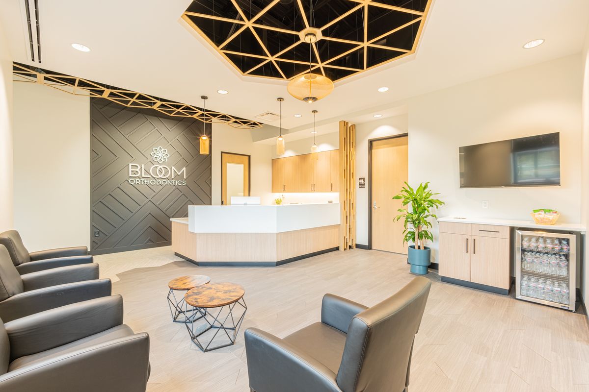 Reception desk and casework by J&M Custom Cabinet Shop at Bloom Orthodontics in Parker, Colorado