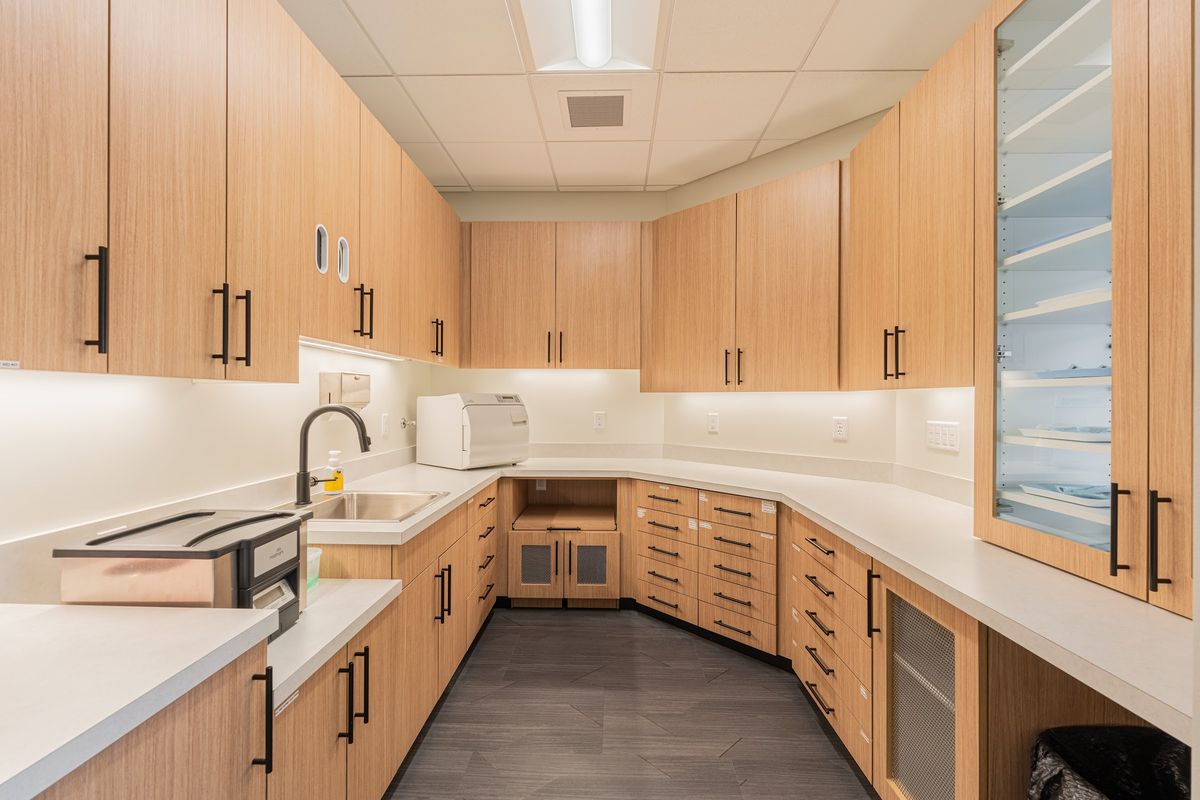 Light wood-grain casework with glass uppers by J&M Custom Cabinet Shop