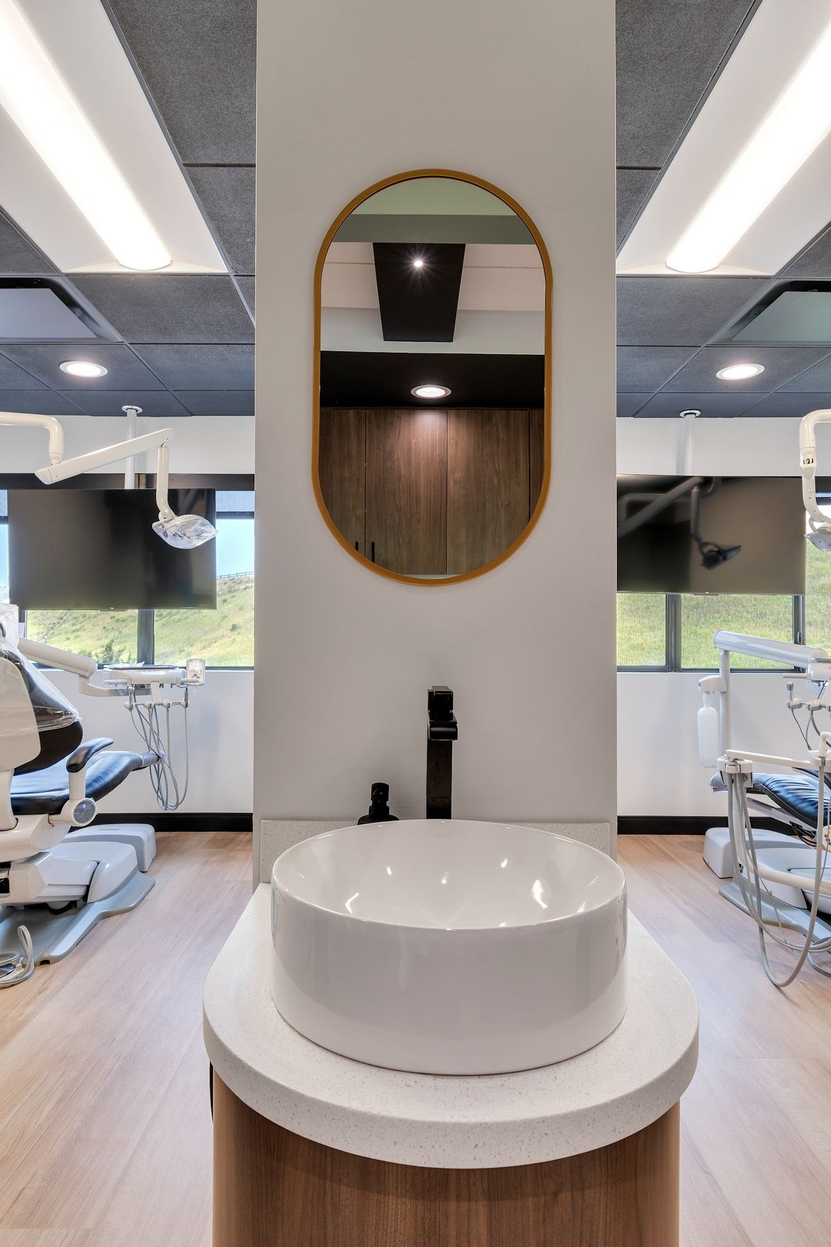 Round sink station with a wood base by J&M Custom Cabinet Shop